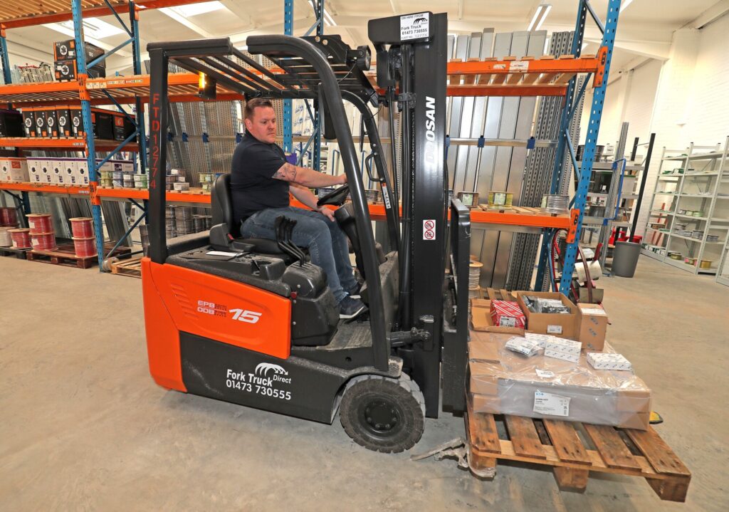 Colchester warehouse with a BEW employee on the FLT