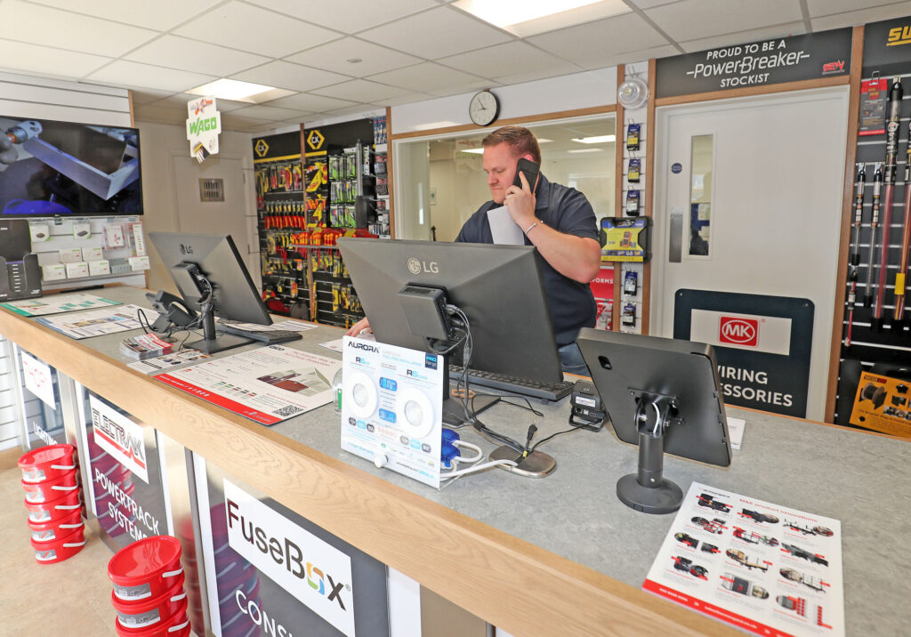 BEW Colchester employee on the phone at our trade counter