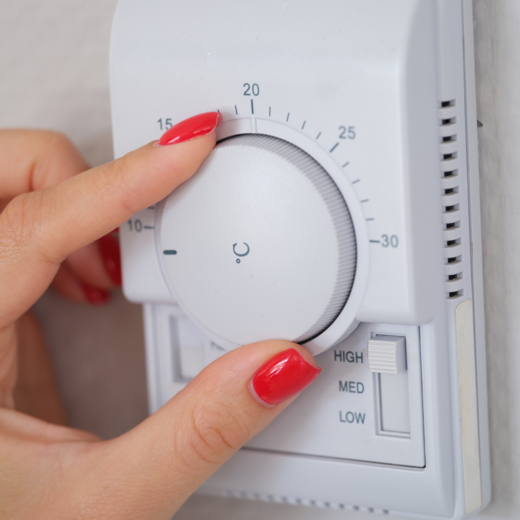 Two fingers controlling the heating controls