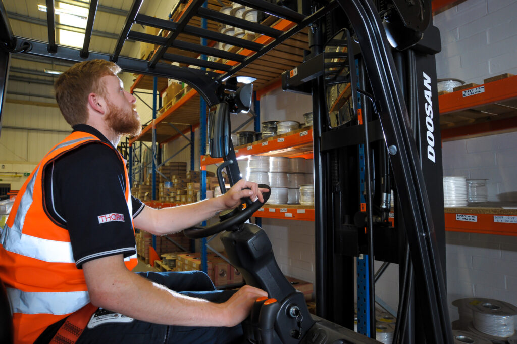 BEW apprentice in a fork lift managing stock